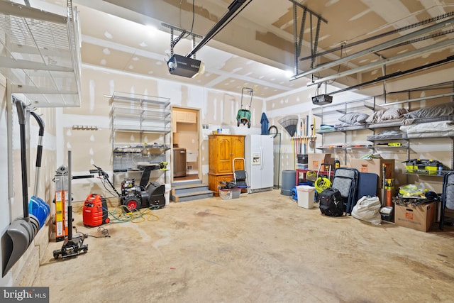 garage with a garage door opener and white refrigerator with ice dispenser