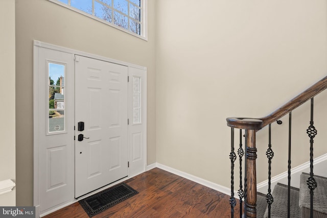 foyer entrance with dark hardwood / wood-style floors