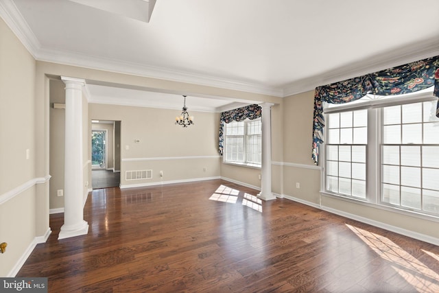 unfurnished room featuring dark hardwood / wood-style floors, ornamental molding, a chandelier, and decorative columns