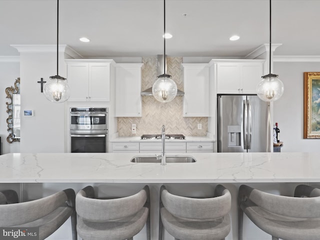 kitchen with appliances with stainless steel finishes, white cabinets, light stone countertops, and decorative light fixtures