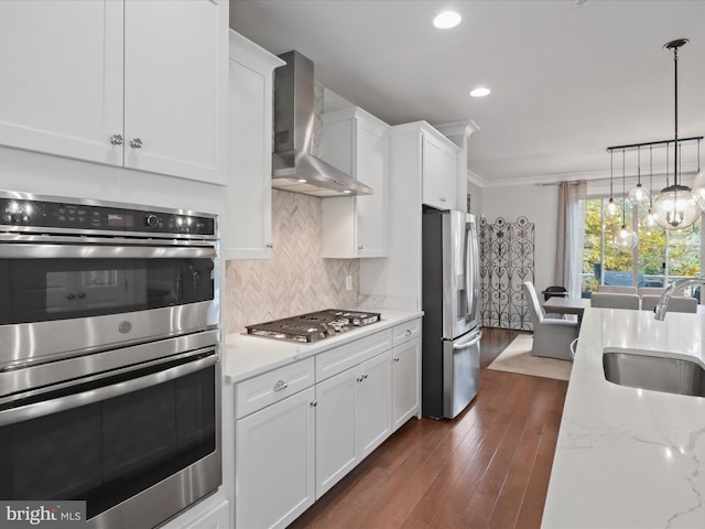 kitchen with stainless steel appliances, wall chimney exhaust hood, dark hardwood / wood-style floors, and white cabinets