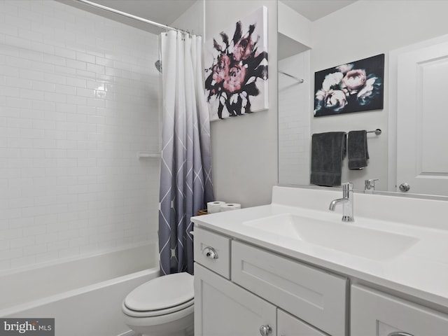 full bathroom with toilet, shower / bath combo with shower curtain, and vanity