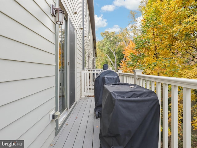 wooden terrace featuring a grill