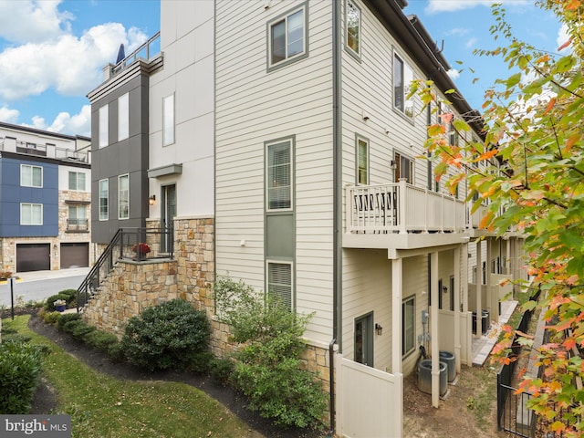 view of side of home with a balcony