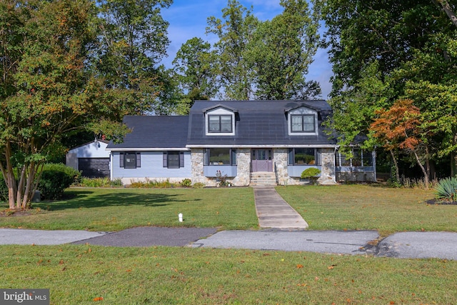 cape cod house with a front yard