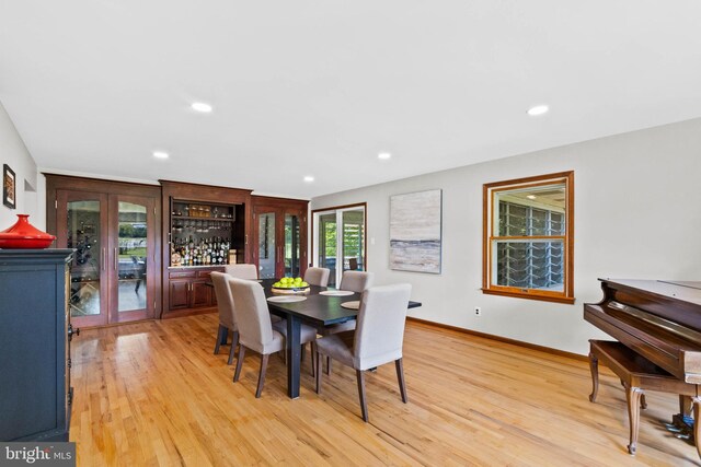 dining room with french doors and light wood-type flooring