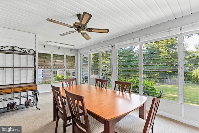 sunroom featuring a healthy amount of sunlight and ceiling fan