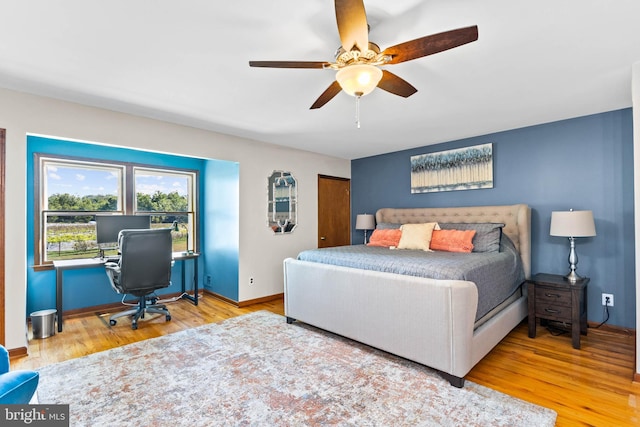 bedroom with hardwood / wood-style flooring and ceiling fan