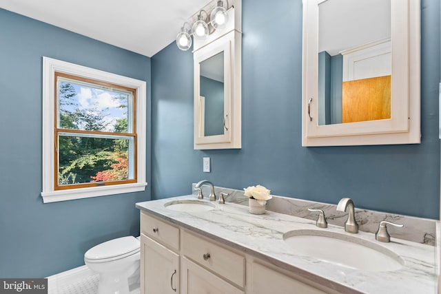 bathroom with vanity, toilet, and tile patterned floors