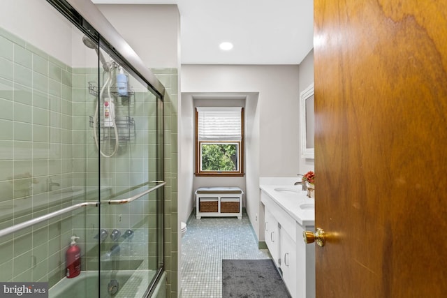 bathroom with vanity, bath / shower combo with glass door, and tile patterned flooring