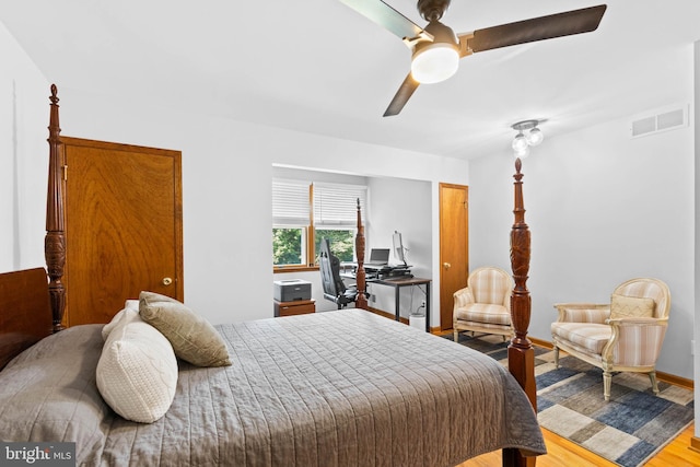 bedroom with light hardwood / wood-style floors and ceiling fan