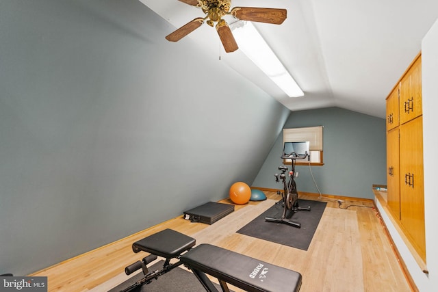 exercise room with lofted ceiling, wood-type flooring, and ceiling fan