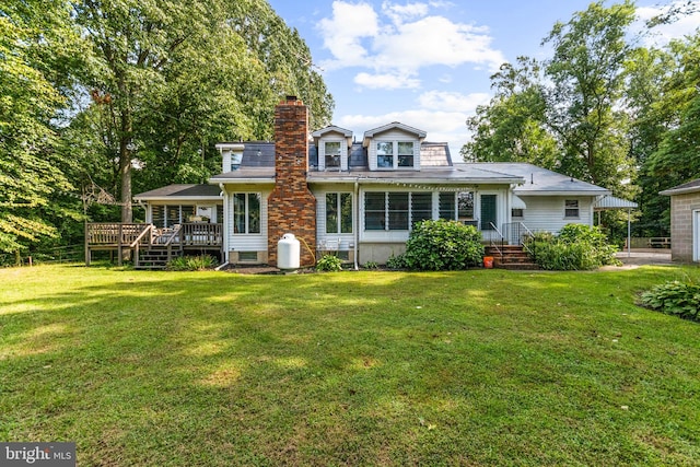 view of front of property featuring a front yard and a deck