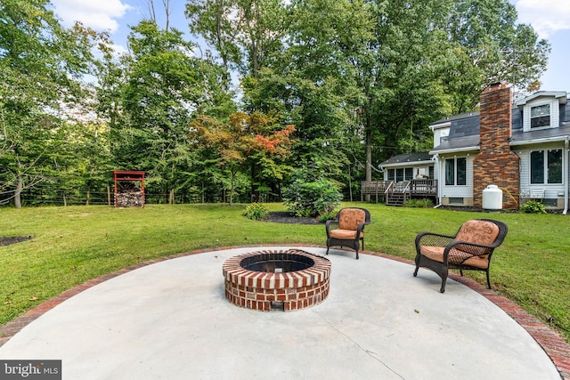 view of patio / terrace with a wooden deck and a fire pit