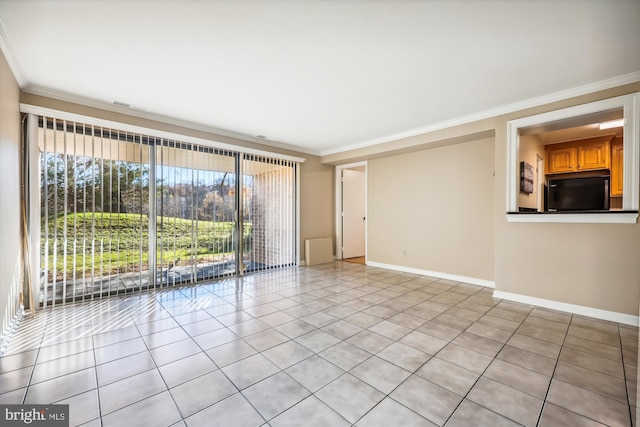 tiled spare room featuring ornamental molding