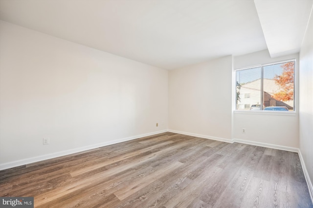 unfurnished room with light wood-type flooring