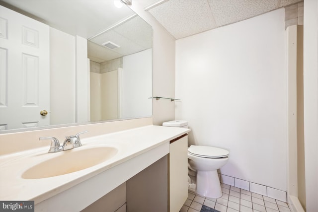 bathroom featuring toilet, vanity, and tile patterned floors