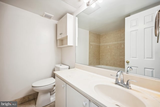 bathroom featuring toilet, tile patterned floors, and vanity