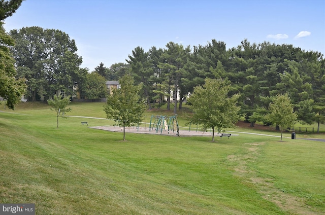 view of home's community featuring a playground and a lawn