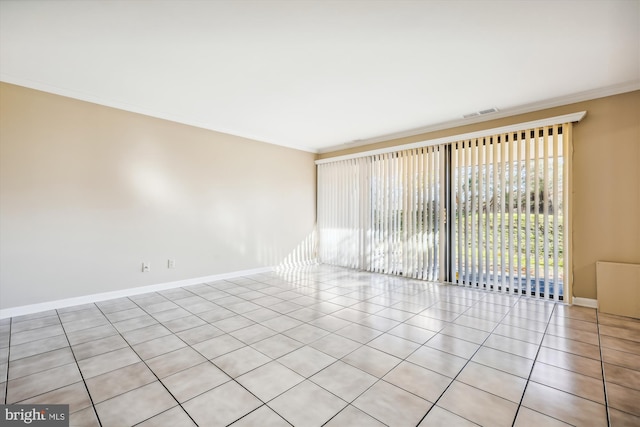 tiled empty room featuring ornamental molding