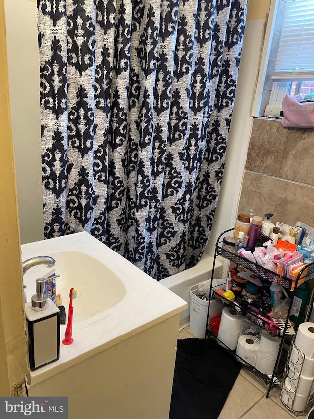 bathroom with vanity, independent shower and bath, tile patterned flooring, and tile walls