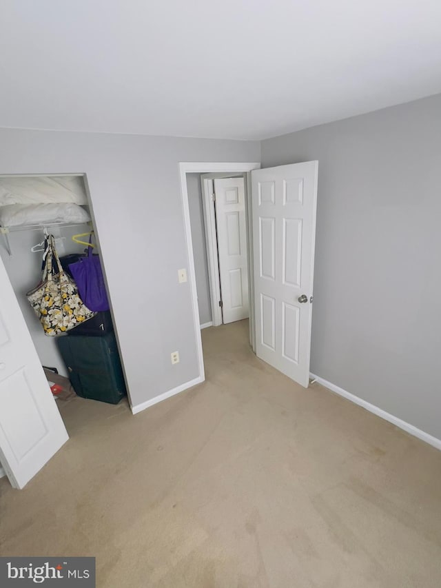 unfurnished bedroom featuring light carpet