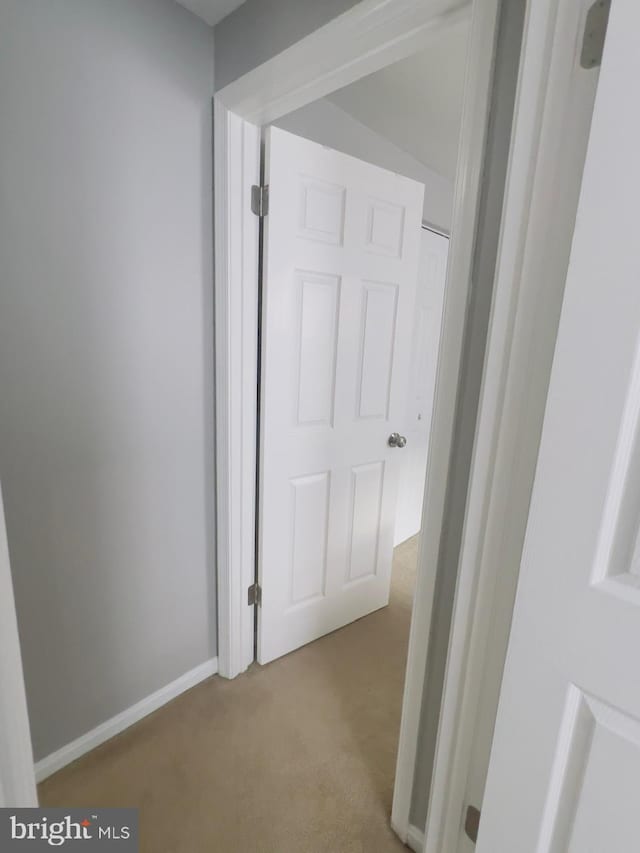 hallway with light colored carpet