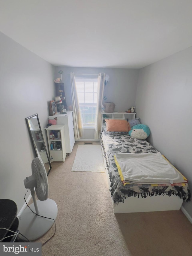 bedroom featuring light colored carpet