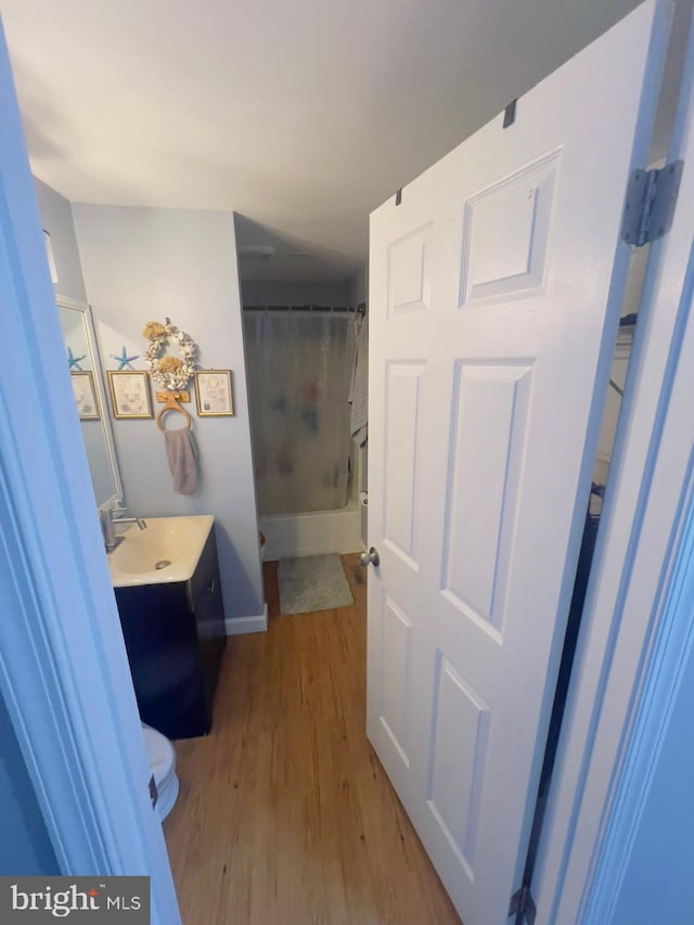 bathroom featuring hardwood / wood-style floors, vanity, and toilet