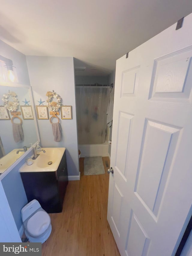 bathroom with shower / bath combo, vanity, and hardwood / wood-style flooring