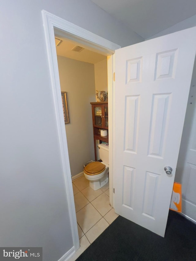 bathroom featuring toilet and tile patterned floors