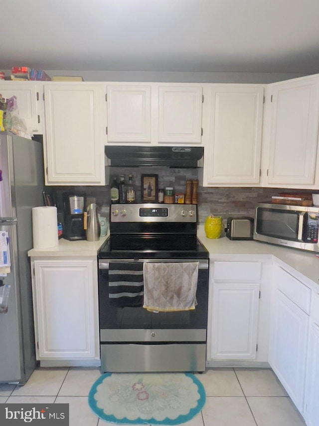 kitchen featuring white cabinets, decorative backsplash, stainless steel appliances, and light tile patterned floors