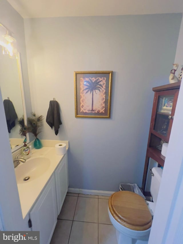 bathroom featuring vanity, tile patterned flooring, and toilet