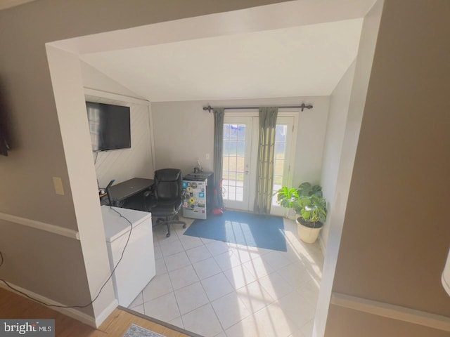 tiled entryway featuring lofted ceiling