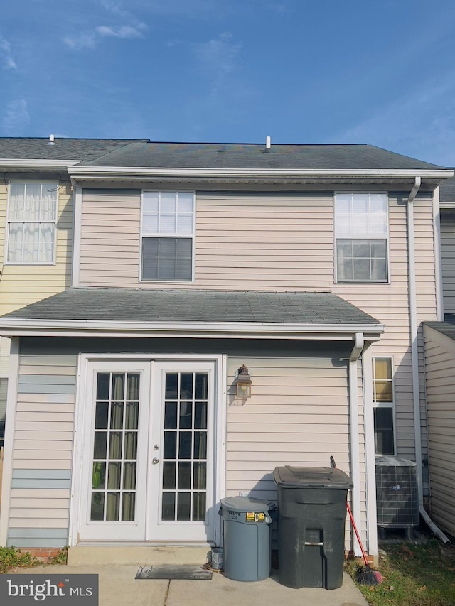 back of house with cooling unit and french doors