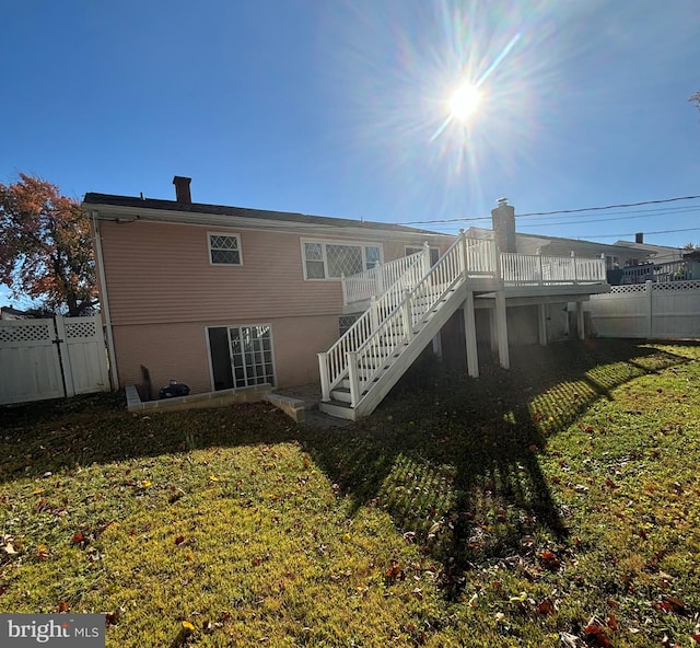 rear view of house featuring a yard