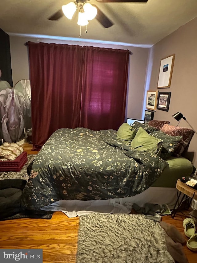 bedroom with wood-type flooring and ceiling fan