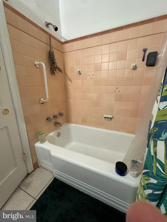 bathroom with tile patterned floors and shower / bath combo with shower curtain