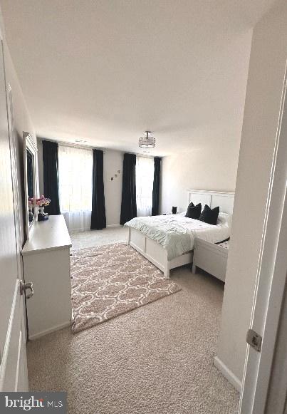 bedroom featuring light colored carpet