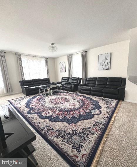 carpeted living room featuring a textured ceiling