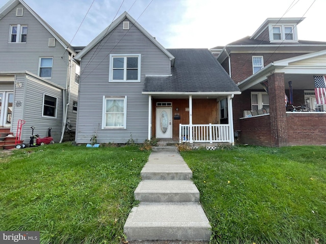 view of front facade featuring covered porch and a front yard