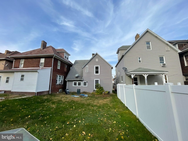 rear view of house with a yard