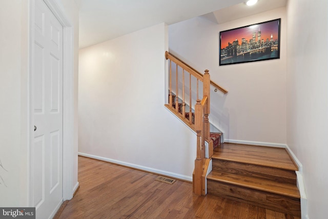 staircase featuring hardwood / wood-style floors