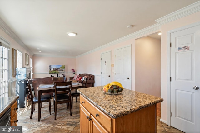 kitchen featuring dishwasher, crown molding, light stone counters, and a kitchen island