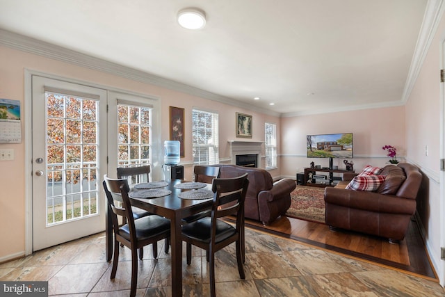 dining room featuring light wood-type flooring and ornamental molding