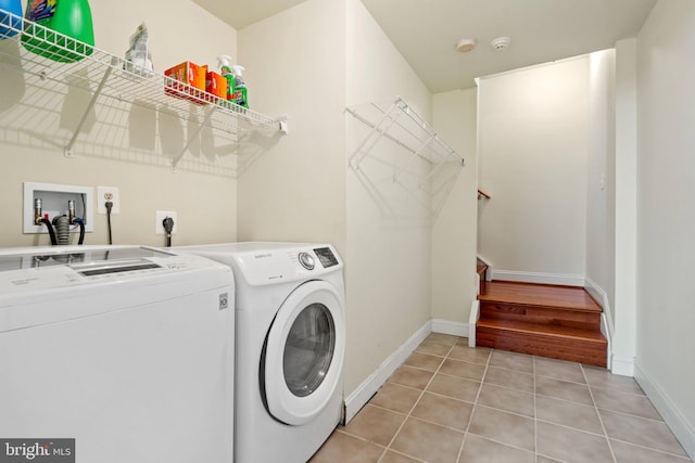 clothes washing area featuring independent washer and dryer and light tile patterned floors