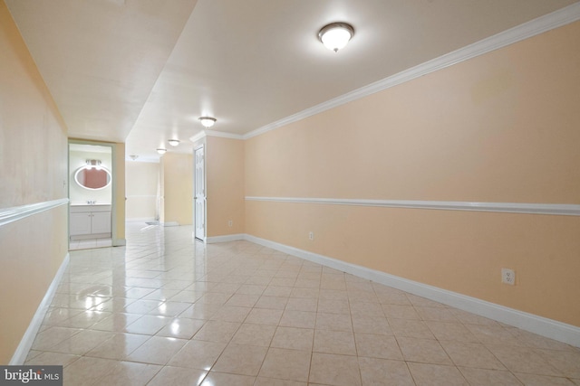 empty room with light tile patterned floors and crown molding