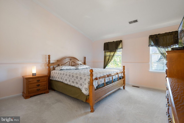 carpeted bedroom featuring lofted ceiling and crown molding