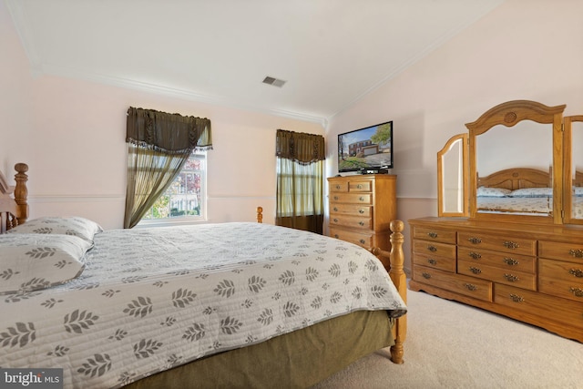 carpeted bedroom featuring vaulted ceiling and crown molding