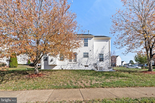 view of side of home featuring a yard